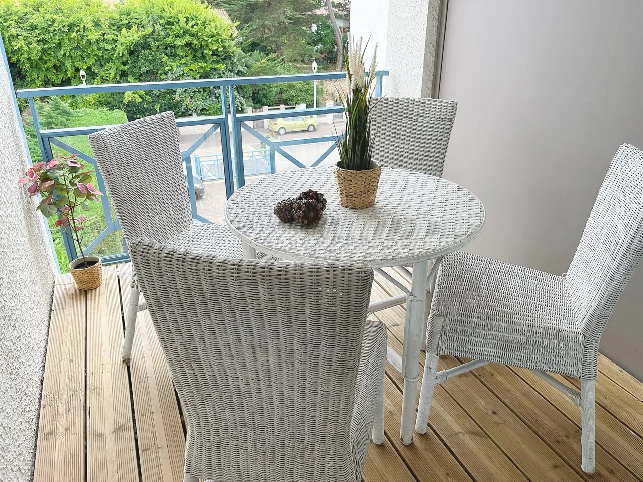 Terrasse privée avec table et fauteuils en osier blanc