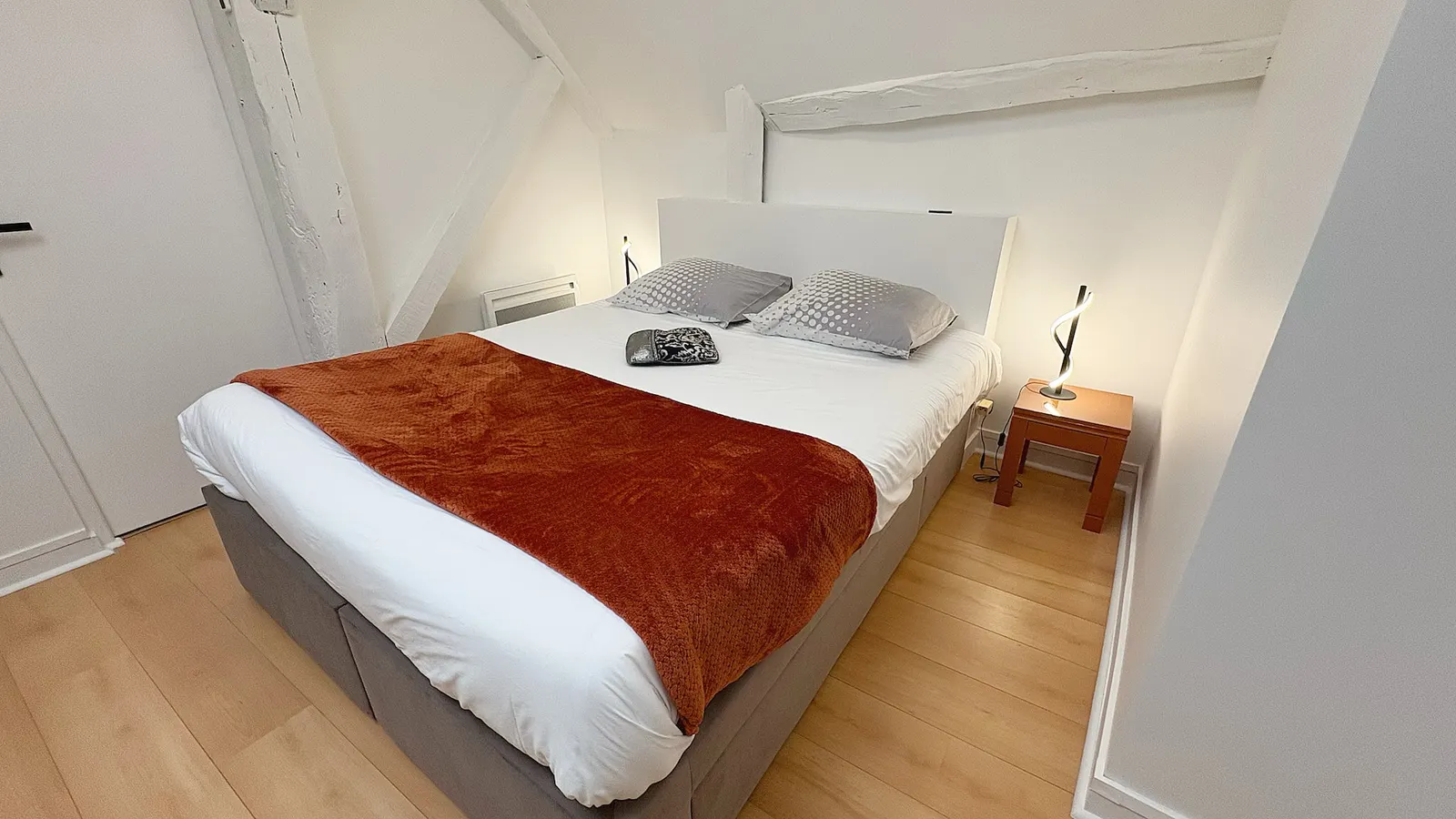 Bedroom under white beams