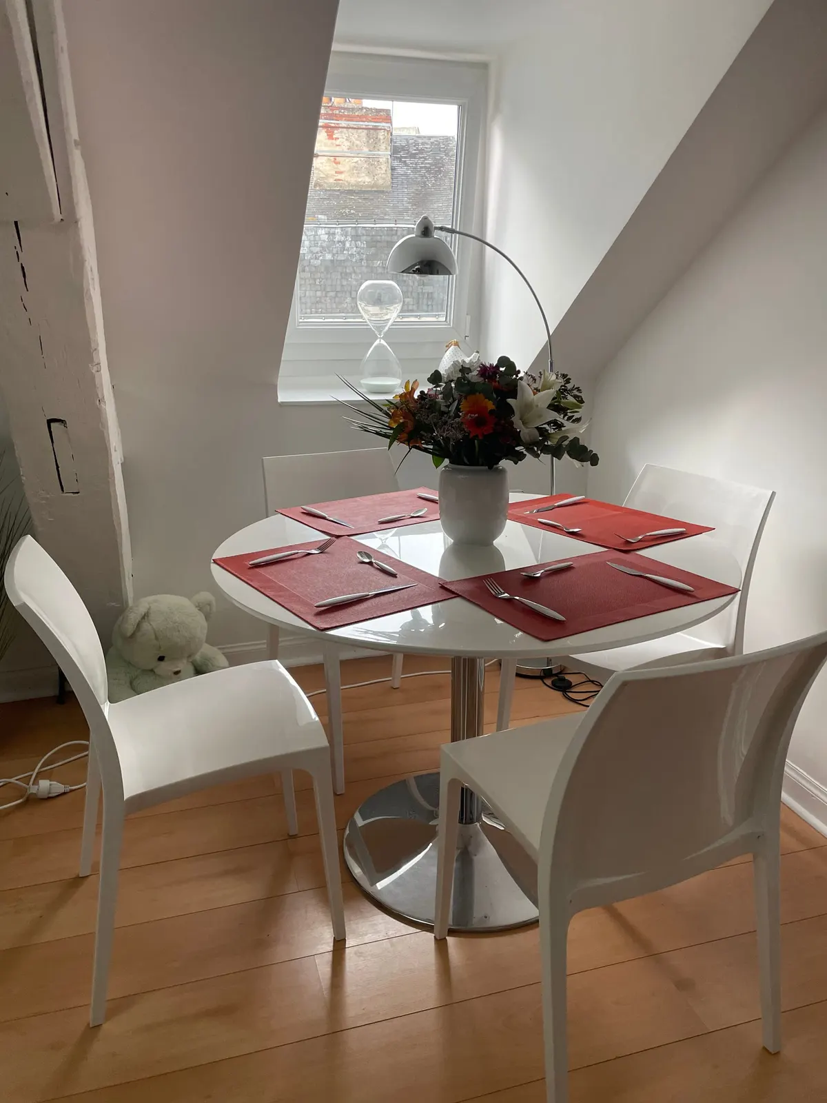 Round table for four under the roof window