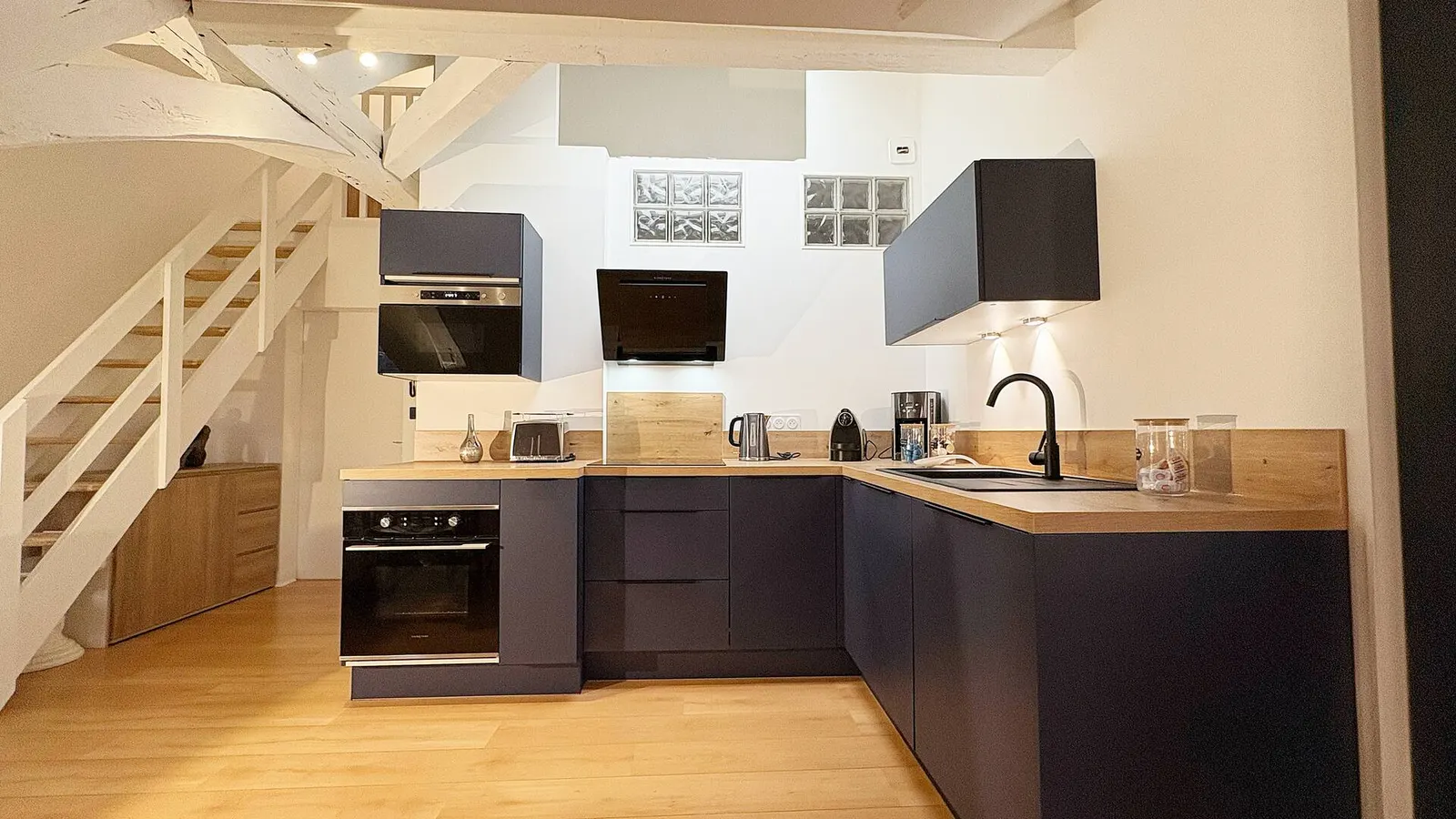 Fitted kitchen under the stairs leading up to the bedroom