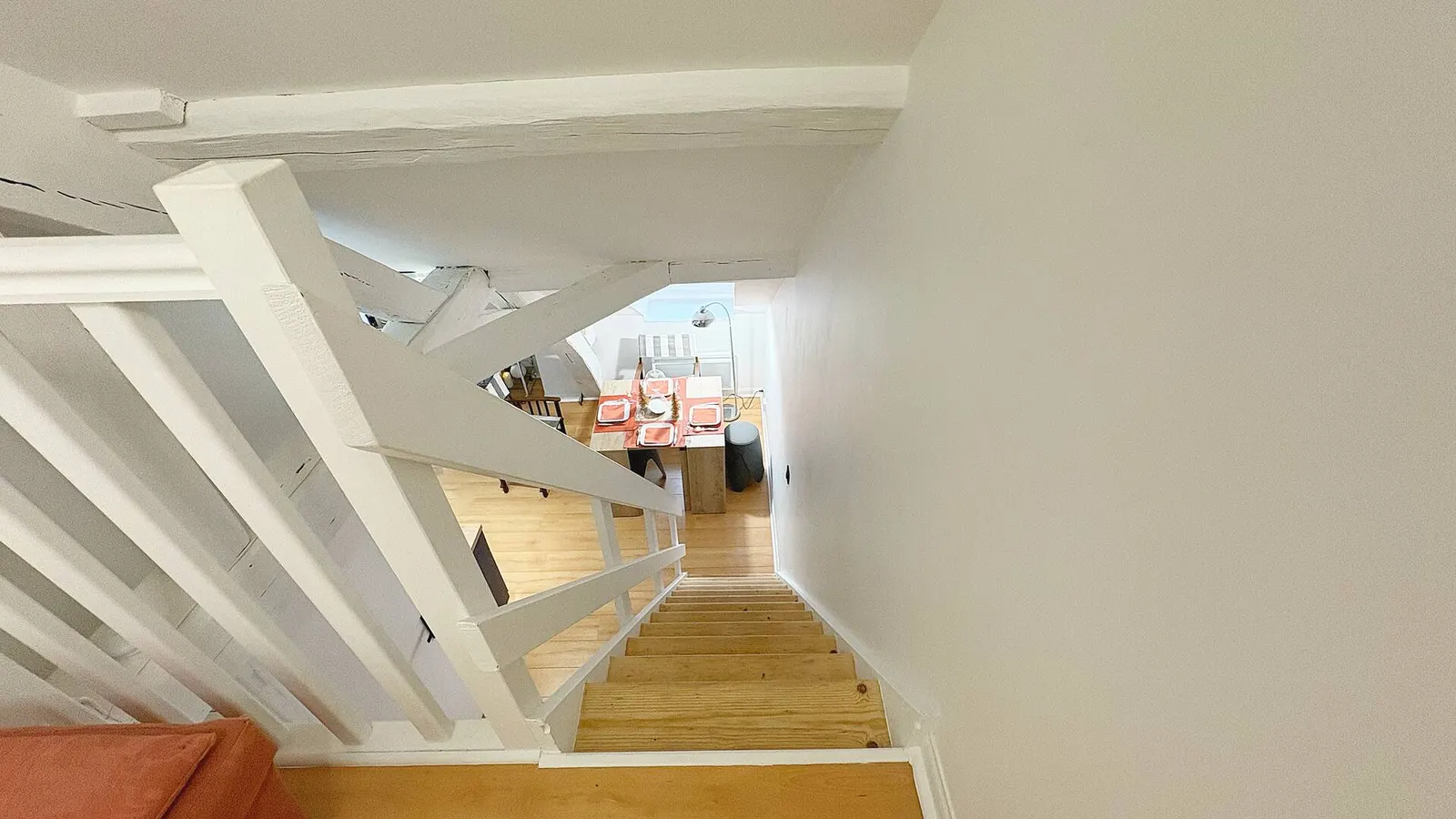 The duplex staircase, bedroom upstairs and living room below