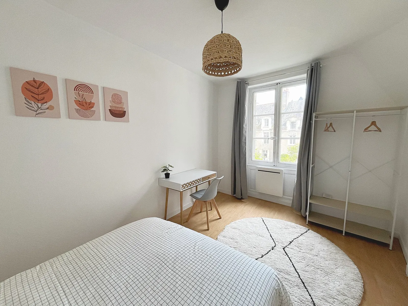 Bedroom with clothes rail and courtyard window
