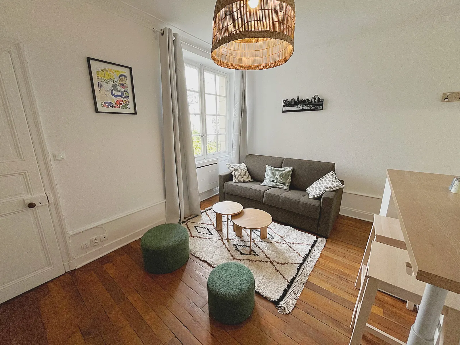 Lounge with sofa bed and green poufs